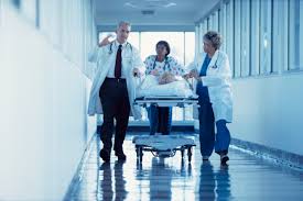 Group of medical professionals transporting a patient in a hospital powered with inverter for continous power supply