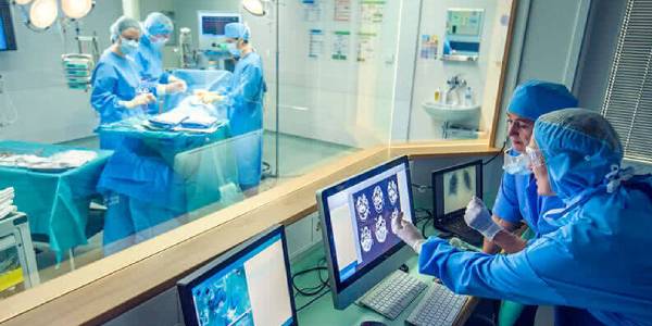 Group of Surgeons in Operation Room and Some Surgeons discussing infront of monitor.